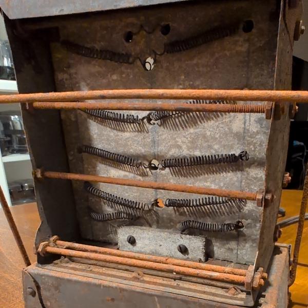 One can observe threaded metal rods affixing either side of the toaster horizontally. Also observe pencil markings locating through holes for the elements horizontally