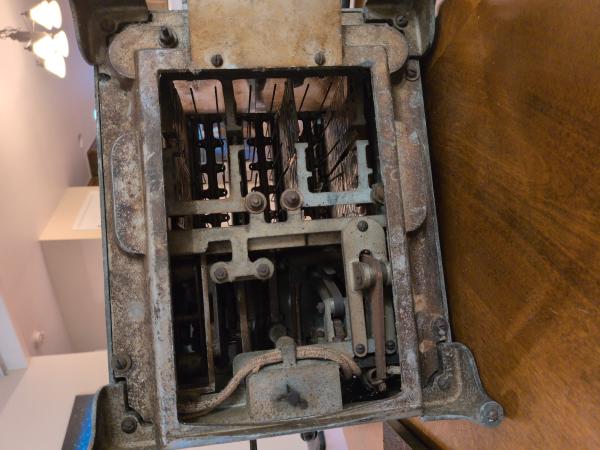 The clockwork internals. The cloth covered wiring is really cleverly routed through the case.